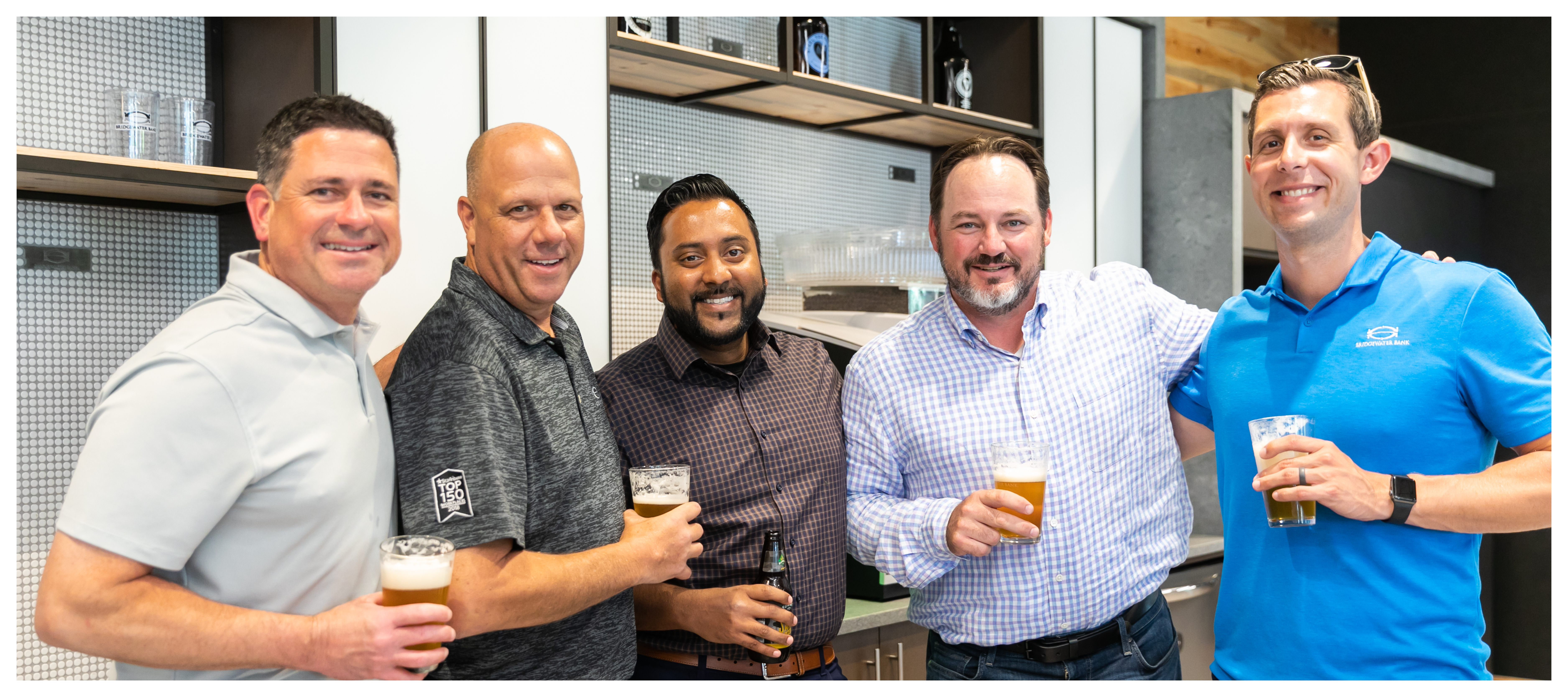 Group photo of Atom Metro Credit Union team members at an internal happy hour.
